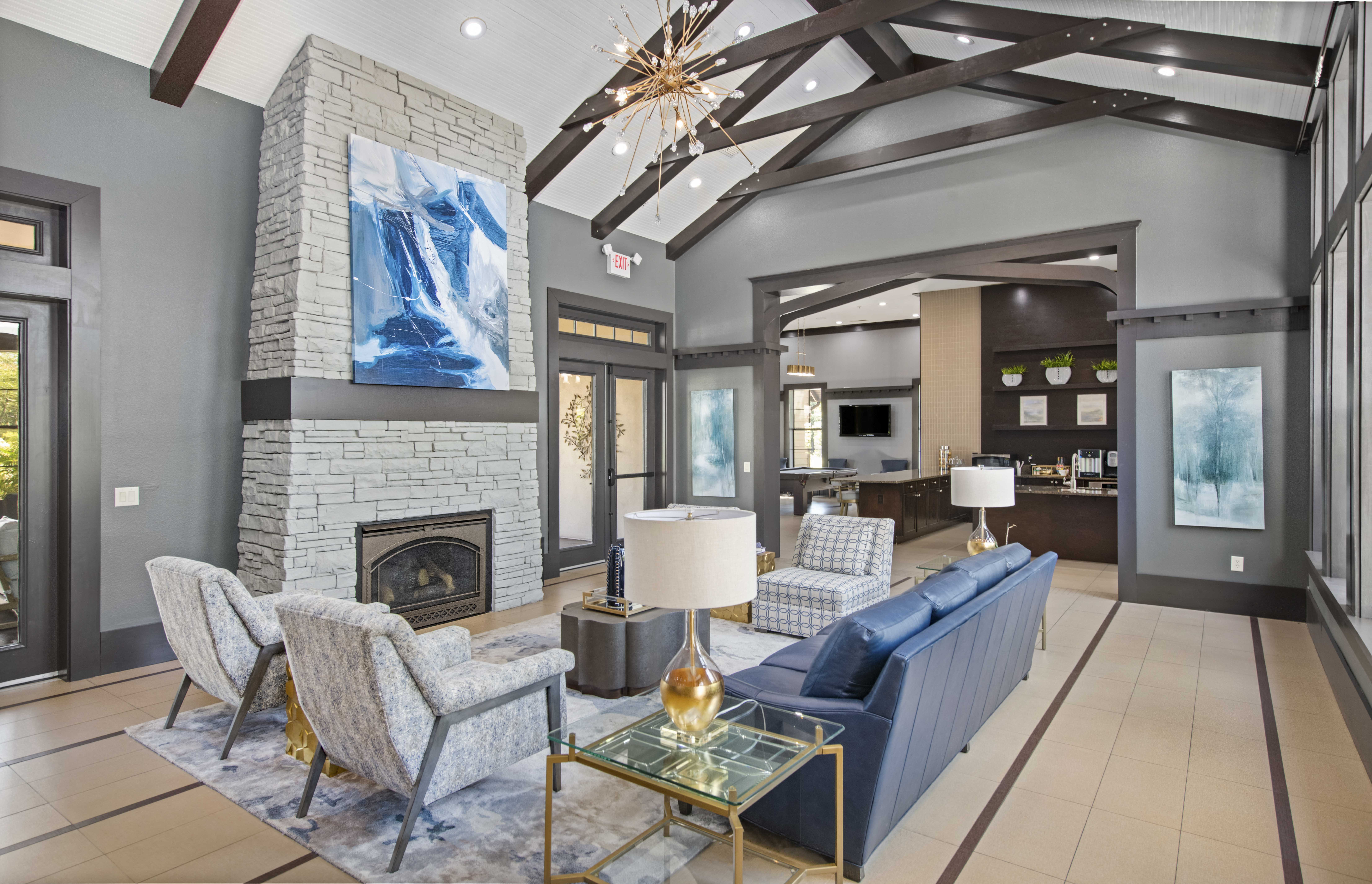 a living room with couches and chairs and a fireplace